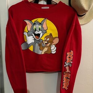 Vibrant red cropped sweatshirt featuring a bold graphic of Tom and Jerry.